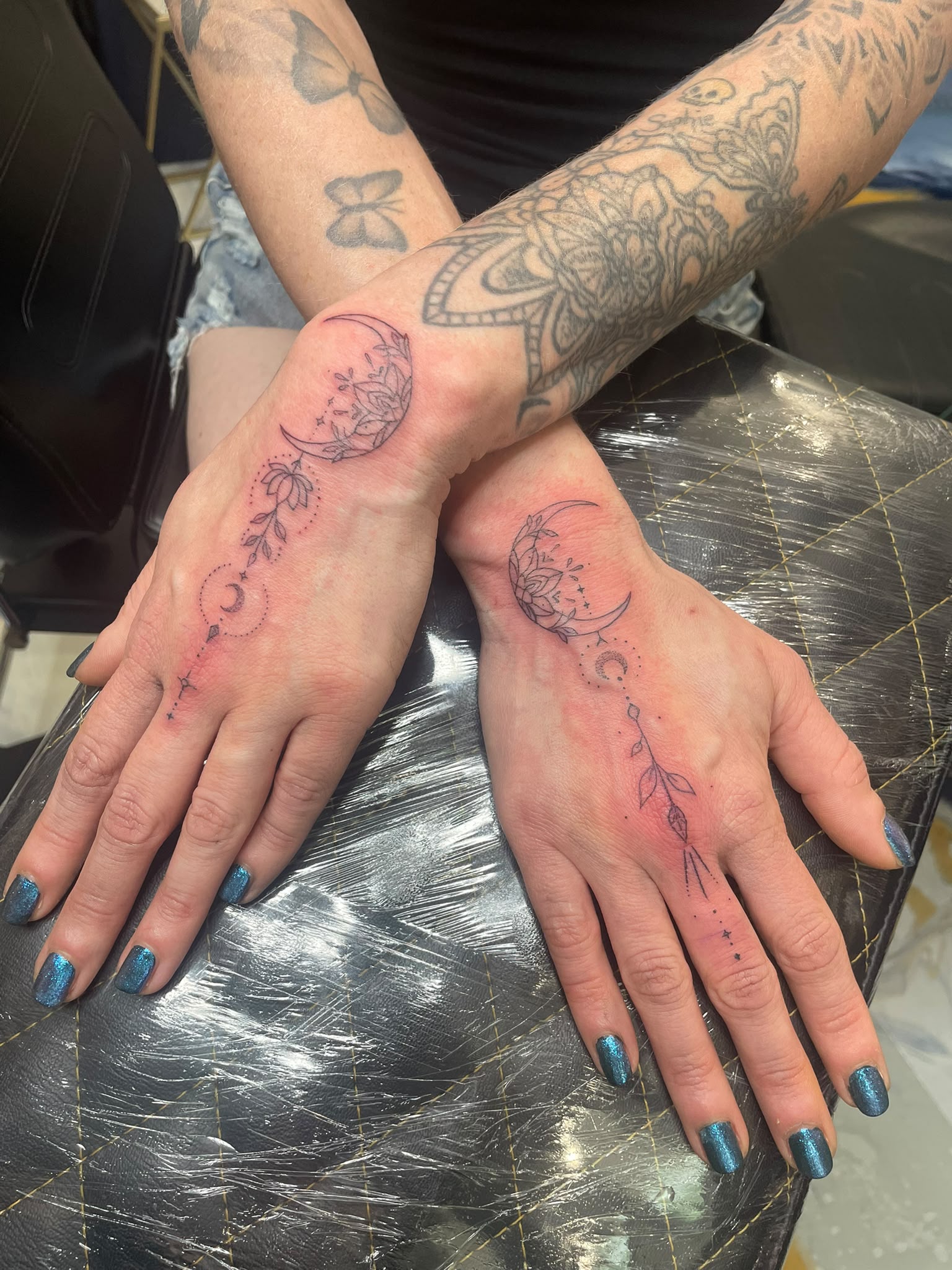 Fine line floral hand tattoos by Turquoise Blue Tattoo Bournemouth